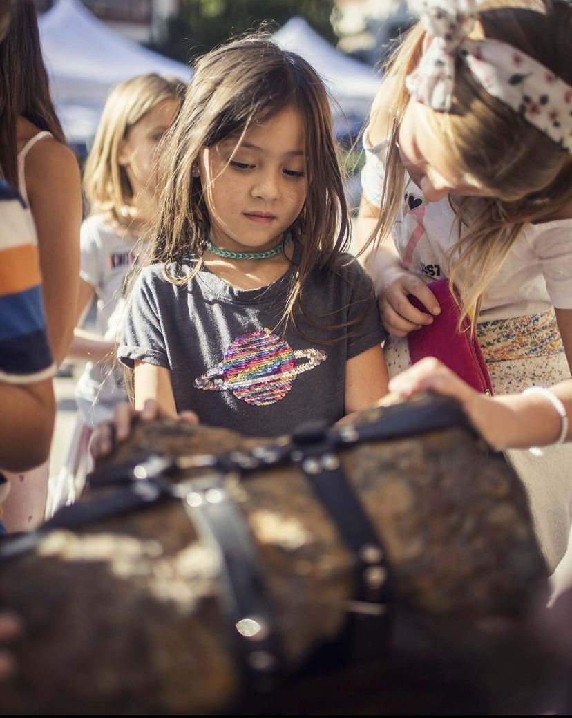 Girl in a planet T-shirt looking at the Inner Freedom art object