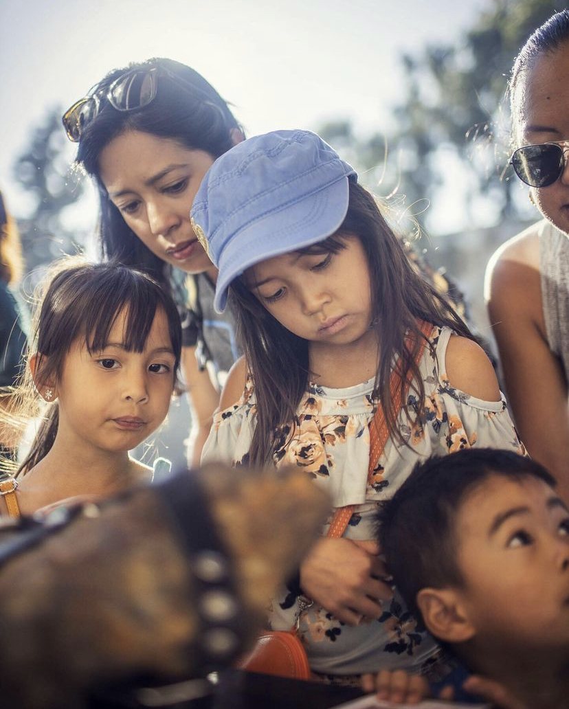 Children and parents gathered around the Inner Freedom meteorite
