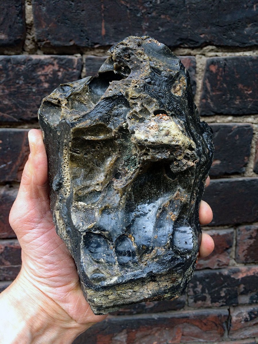 Glassy Zhamanshin impact melt held in hand